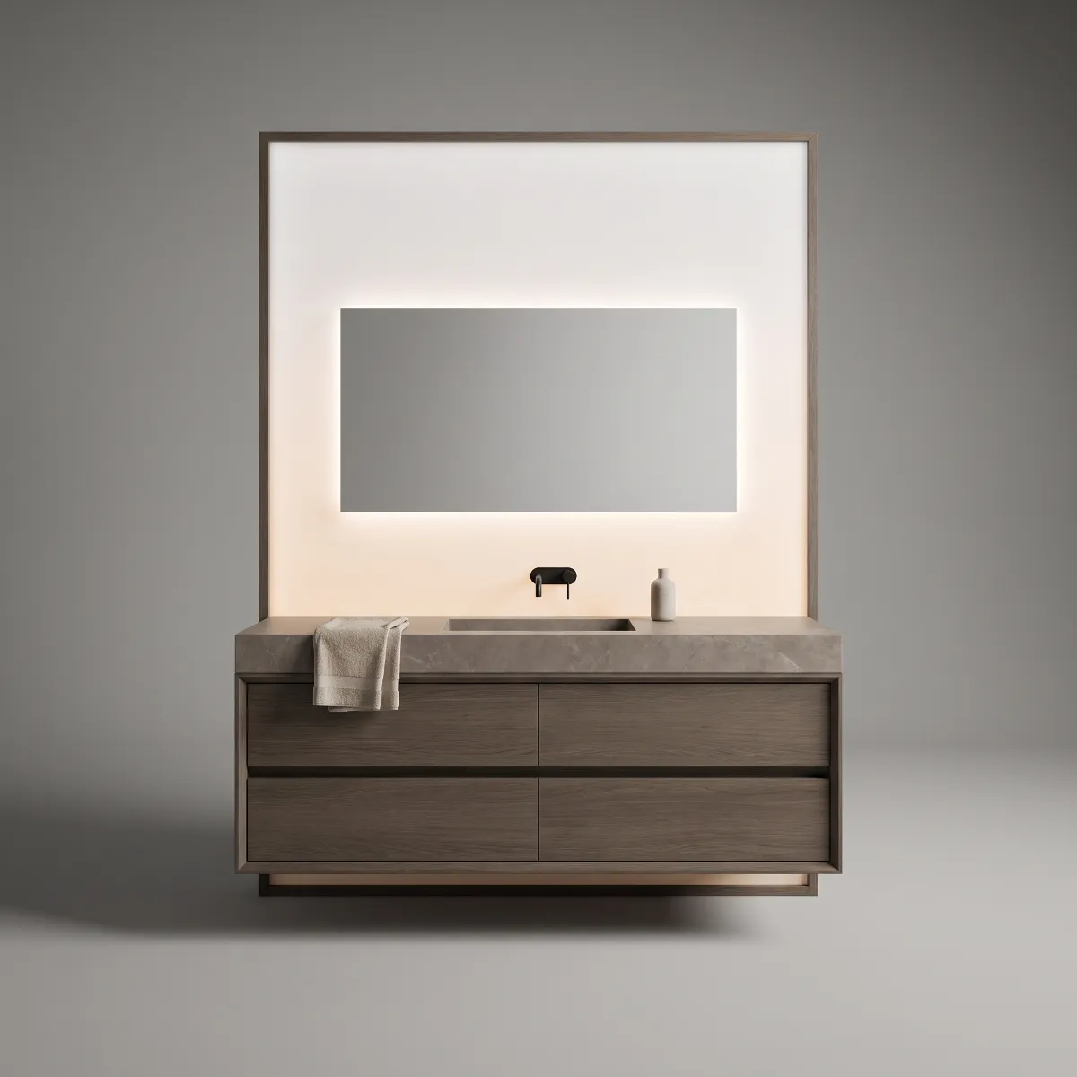 A smoked oak vanity with a grey marble top in front of a backlit panel and mirror